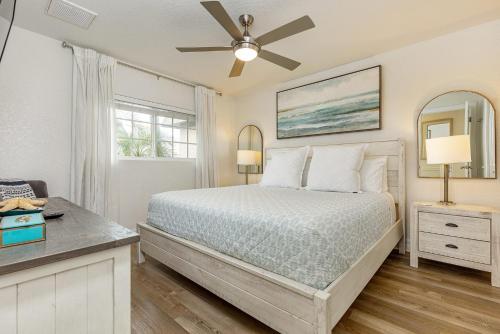 a bedroom with a bed and a ceiling fan at Heat of Siesta Village Walk to Beach w heated Pool in Siesta Key