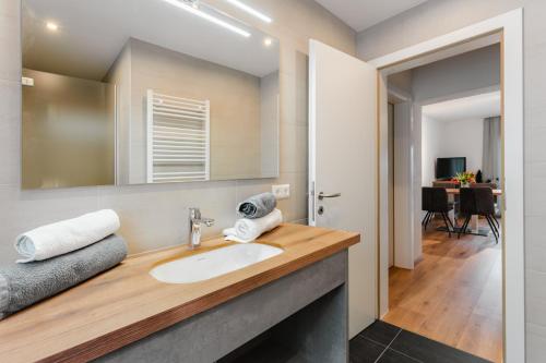 a bathroom with a sink and a mirror at Haus Nowak Ferienwohnungen in Millstatt