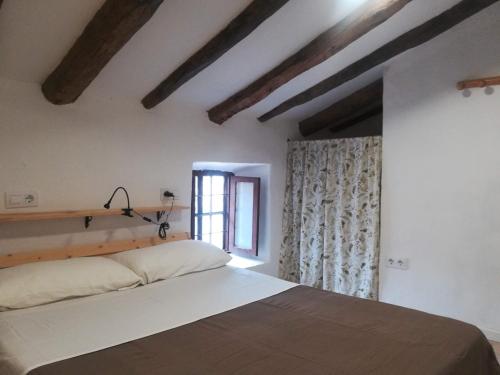 a bedroom with a bed and a window at CASA RURAL REVOLCADORES in Moratalla