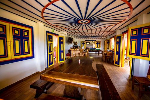 a living room with a wooden table in the middle at Hotel Terra Belén in Belén de Umbría