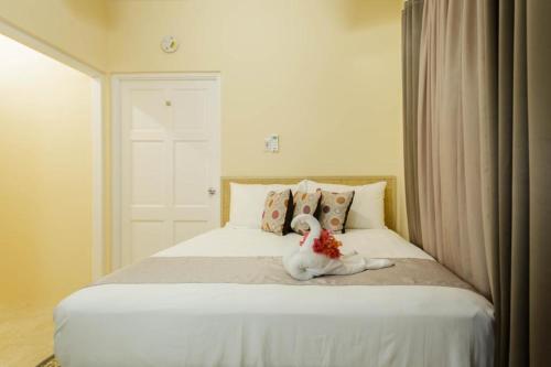 un animal de peluche blanco sentado en una cama en Cozi Cottage, A Tranquil Beauty en The Rock