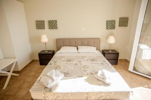 a bedroom with a large bed and two lamps at Musses Studios in Minia