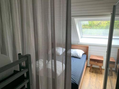 ein kleines Schlafzimmer mit einem Bett und einem Fenster in der Unterkunft Chez Felix gezellig vakantiehuis in Hotton in Hotton