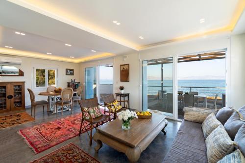 a living room with a couch and a table at Seaside Private Beach Paradise in Kos