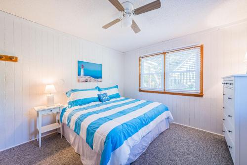 a bedroom with a bed and a ceiling fan at Coker Cabana in Sanderling