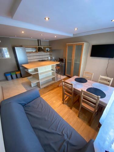 a living room with a blue couch and a table at Podkarpacka 50 in Rzeszów