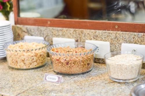 three bowls of oatmeal sitting on a counter at Map Hotel in Lages