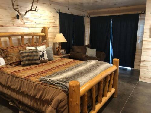 a bedroom with a large wooden bed in a log cabin at Newly Built, Fire Pit, Kitchen in Rea