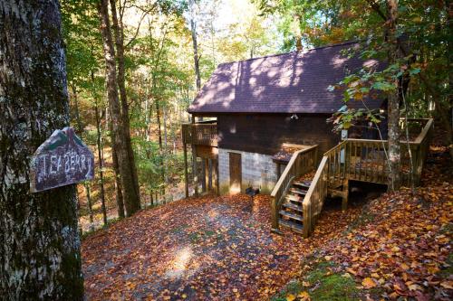 a cabin in the woods with leaves on the ground at A Cabin In The Woods in Pigeon Forge