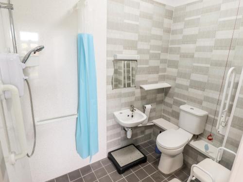 a bathroom with a toilet and a sink at Bank House in Mablethorpe