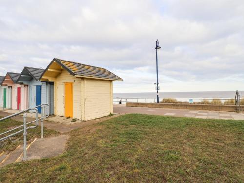 a row of colourful beach huts on the beach at Bank House in Mablethorpe
