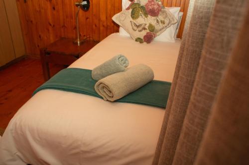 a hotel room with two towels on a bed at Sodwana Bay Lodge House 34 in Sodwana Bay