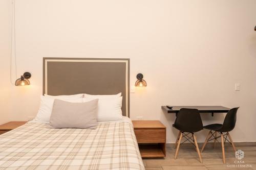 a bedroom with a bed and a desk and a chair at Casa Guillermina in Durango