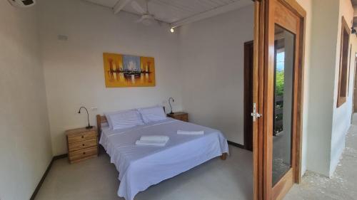 Ένα ή περισσότερα κρεβάτια σε δωμάτιο στο Casa Mangue
