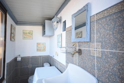 a bathroom with a toilet and a mirror at Masì House in Rhodes Town