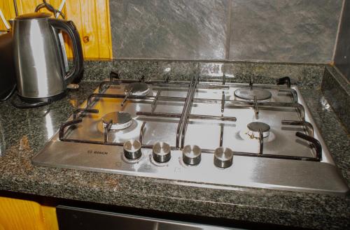 a stove top with four burners on a kitchen counter at Sodwana Bay Lodge House 34 in Sodwana Bay