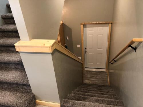 a stairway with a white door and some stairs at Loft, Kitchen, Washer,Dryer in Island Park