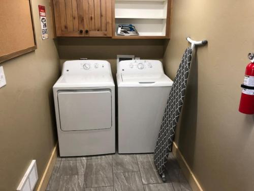 a laundry room with two washes and a washer at Patios, Hot Tub, Yellowstone in Rea