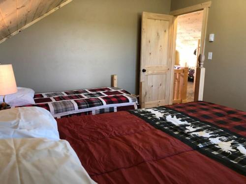 a bedroom with two beds in a room at Patios, Hot Tub, Yellowstone in Rea