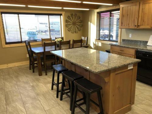 a kitchen with a large island with bar stools at Patios, Hot Tub, Yellowstone in Rea
