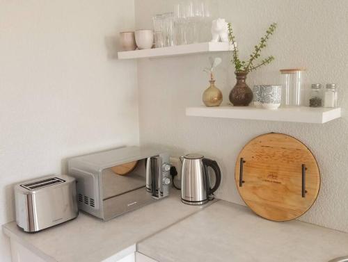 a kitchen counter with a toaster and a coffee maker at Charming Studio in Stellenbosch - The Valley Stay in Stellenbosch