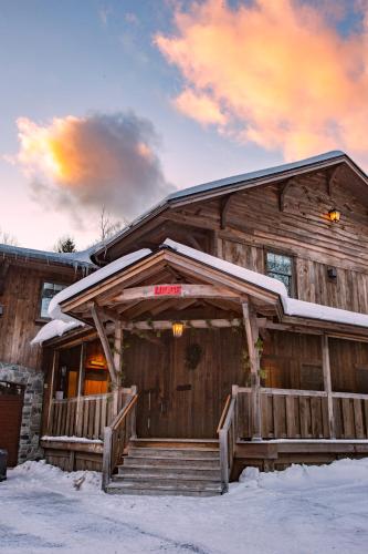 a log cabin with snow on the roof at Seesaw's Lodge in Peru