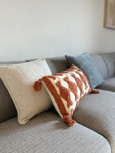 a brown and white pillow on a couch at Valentine's House in Óbidos