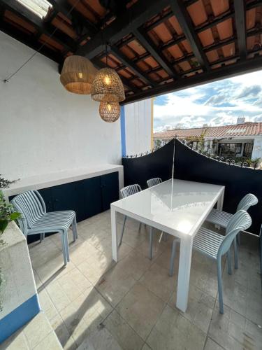 a white table and chairs on a patio at Valentine's House in Óbidos