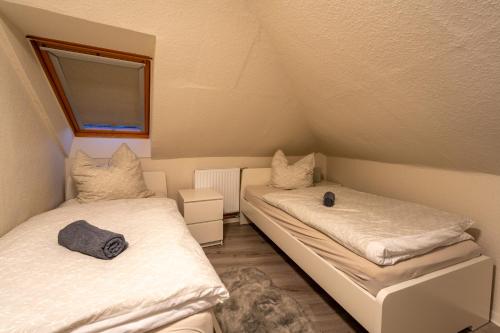 a room with two beds in a attic at Bördeapartment am Heiderand 
