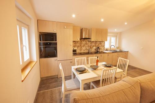 a kitchen and dining room with a table and a couch at Quintana&lev in Viveiro