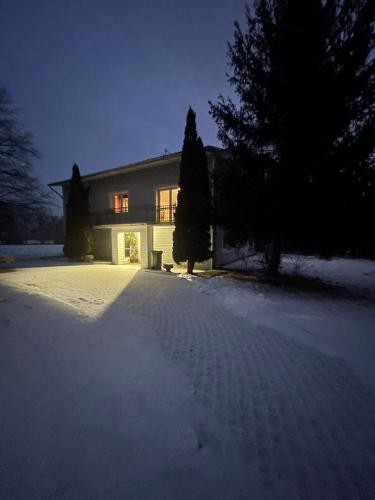 a house with snow on the ground in front of it at Podkarpacka 50 in Rzeszów