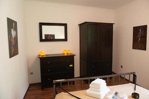 a bedroom with a dresser and a black cabinet at EUFORY BDSM-Domizil in Hamburg