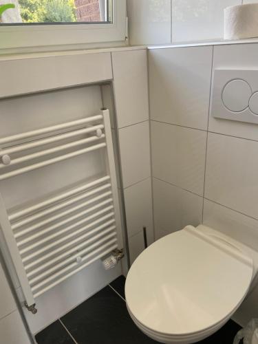 a small bathroom with a toilet and a window at MarlFlats in Marl