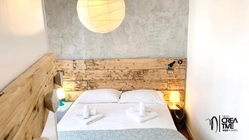 a bedroom with a bed with two white pillows at Hotel Nizza Creative Hotel in Rimini