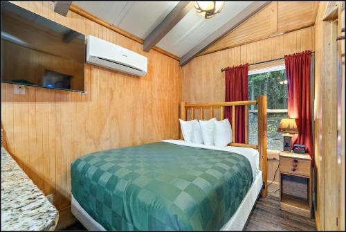 a bedroom with a bed in a room with a window at Brundage Bungalows in McCall