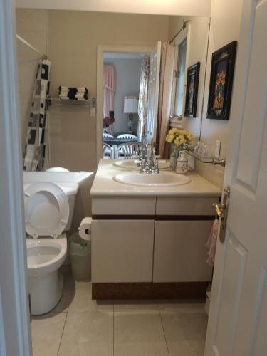 a bathroom with a toilet and a sink at Lakeview private suite with kitchen-Twin or king in Tottenham