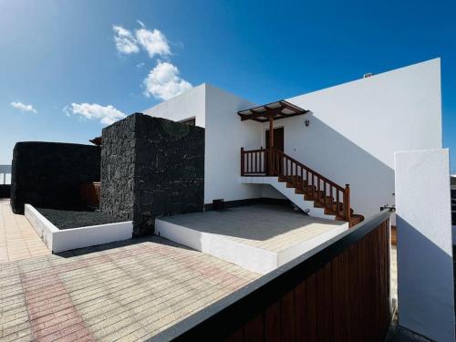 a house with a staircase on the roof at Lovely Casa Sueños, heated pool x snooker table in Playa Blanca