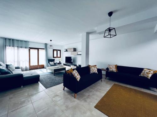 a living room with blue couches and a living room with at Casa Sueños in Playa Blanca