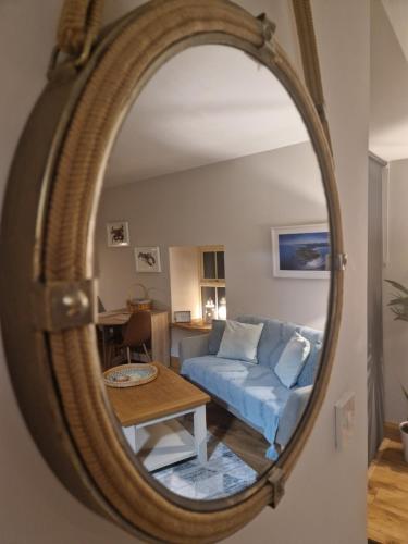 a living room with a blue couch and a mirror at Ard Na Mara, Mullaghmore, Sligo in Mullaghmore