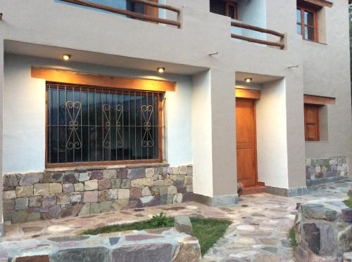 a house with a gate on the front of it at Casa en Tilcara con hermosa vista al Pucara in Tilcara