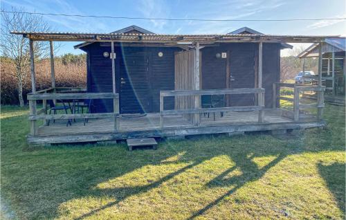 eine kleine Holzhütte mit einem Tisch und einer Bank in der Unterkunft Brittas Stuga in Visby