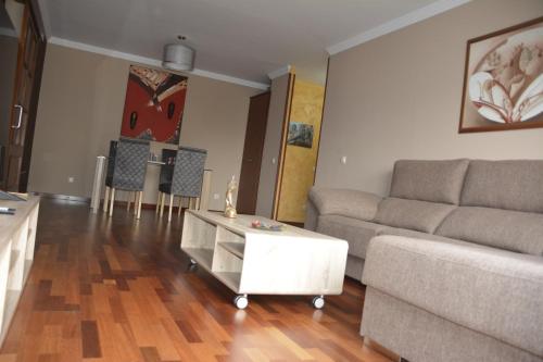 a living room with a couch and a coffee table at Apartamento complejo residencial in Las Palmas de Gran Canaria
