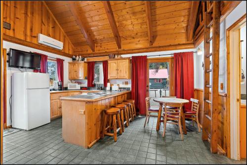 a kitchen with a white refrigerator and a table at Brundage Bungalows in McCall