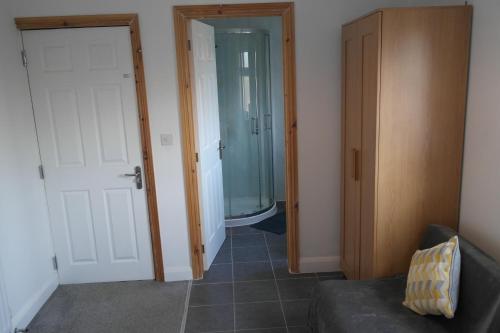 a hallway with a glass door leading to a bathroom at Sheridan House I Long or Short Stay I Special Rate Available in Derby