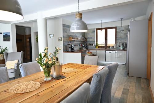 una cucina e una sala da pranzo con tavolo e sedie in legno di Babie Zacisze a Zawoja