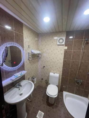 a bathroom with a sink and a toilet and a mirror at طارق الطائف in Taif