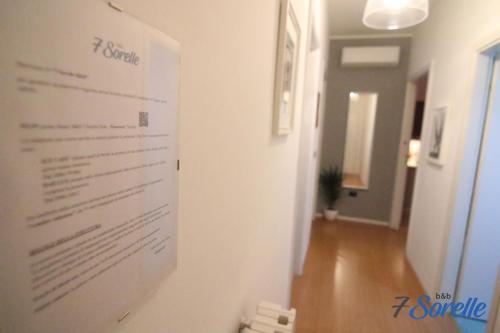 a sign hanging on a wall in a room at "7 SORELLE B&B" camere in pieno centro città con bagno privato, FREE HIGH SPEED WI-FI, NETFLIX in Cosenza