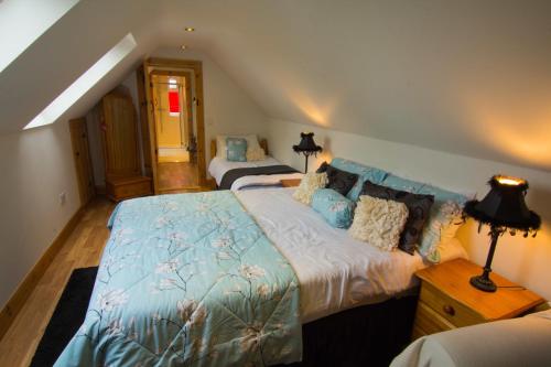 a bedroom with two beds in a attic at The Thatched Cottage B&B in Claregalway