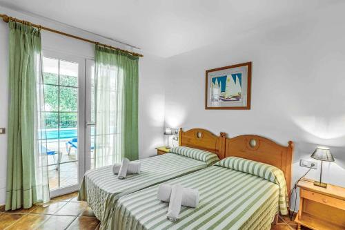 a bedroom with a bed with two pillows on it at Villa Agua Marina in Binibeca