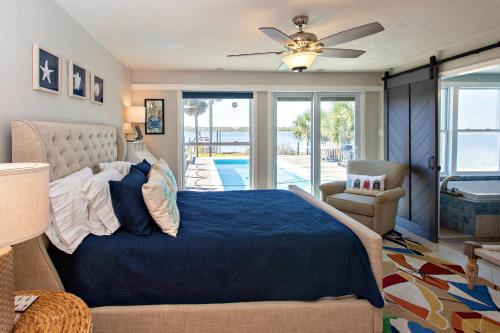 a bedroom with a bed and a ceiling fan at 3170 S Peninsula Drive in Daytona Beach